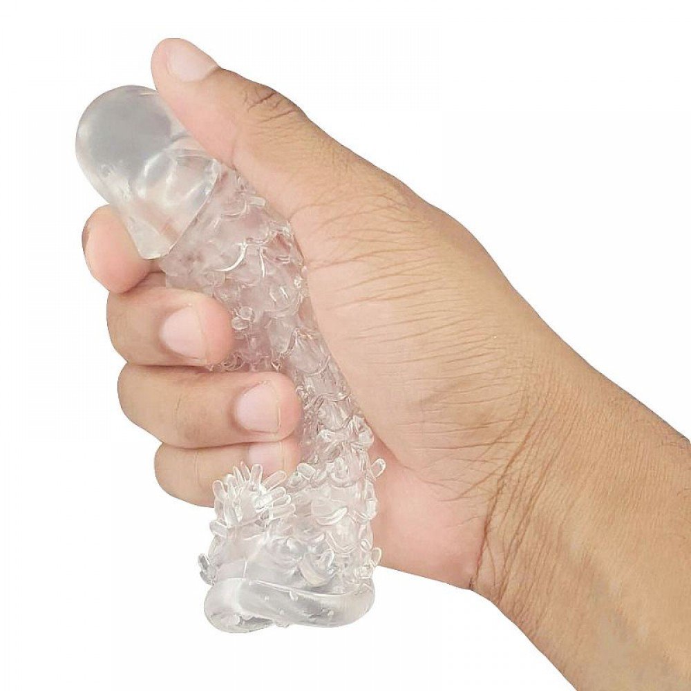 Capa peniana Texturizada transparente Capa Texturizada com Estimulador de Clitóris é feita de gel transparente com nódulos massageadores que proporcionam uma estimulação intensa à região clitoriana. Capa peniana Texturizada transparente